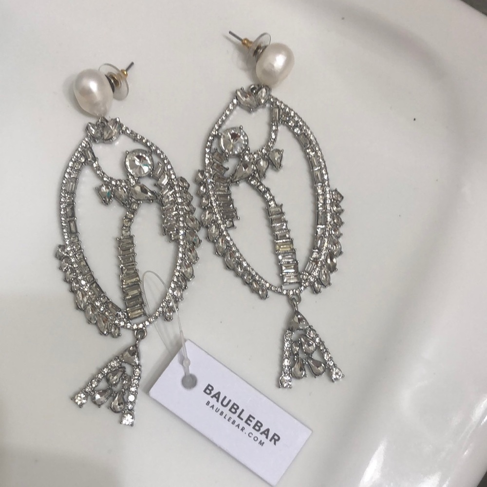 Stunning Earrings Look like fish or ladies.